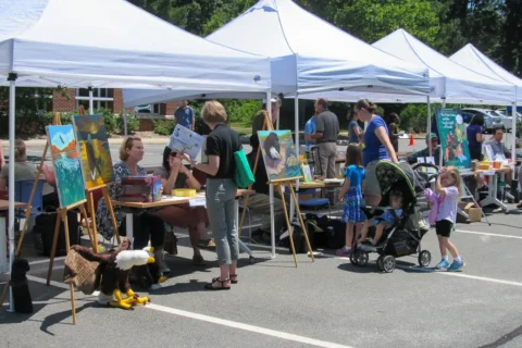 Guests browse author tents at the Eat Local Read Local event.