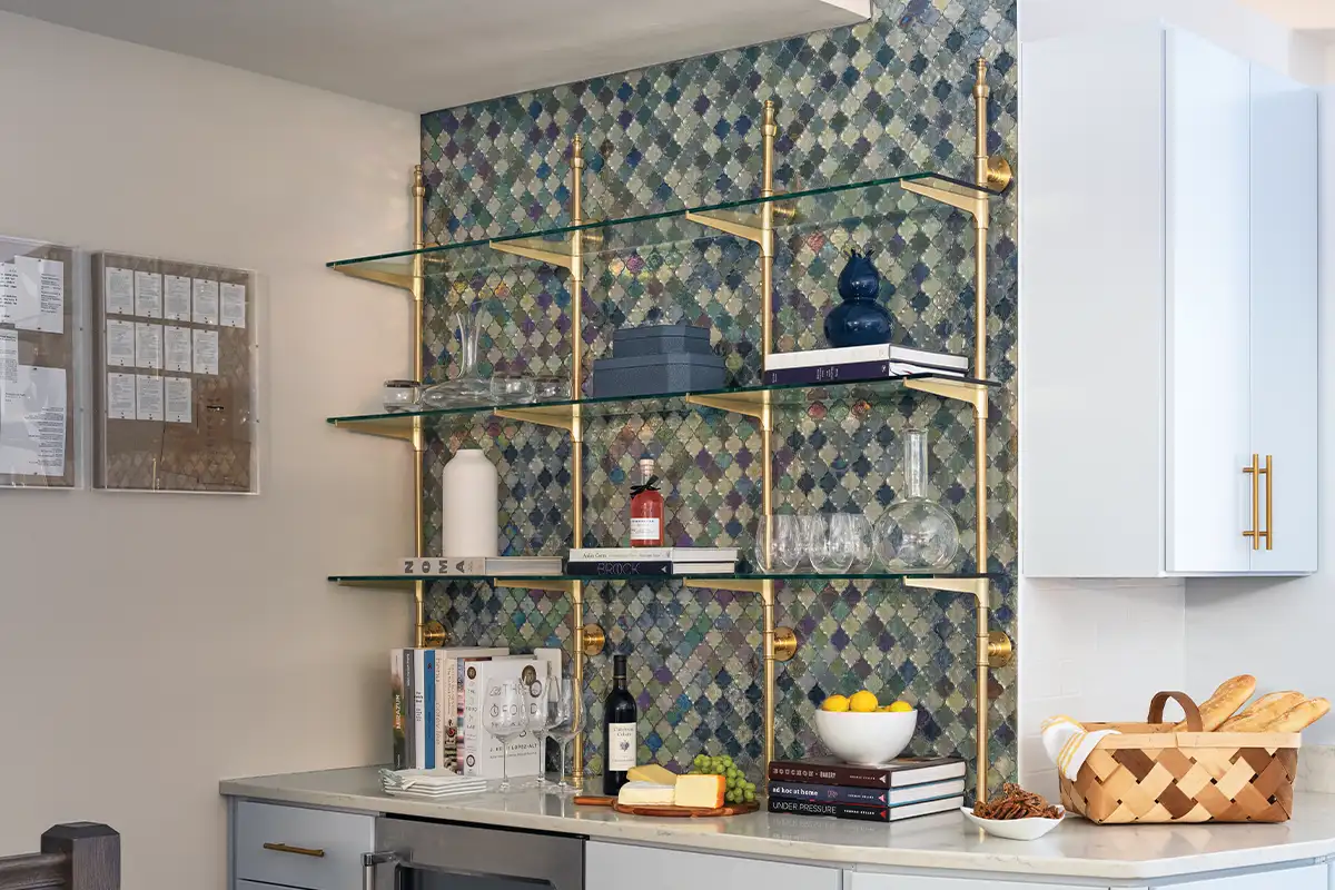 Brass shelves and a blue tile backsplash at the French-inspired Del Ray townhouse.