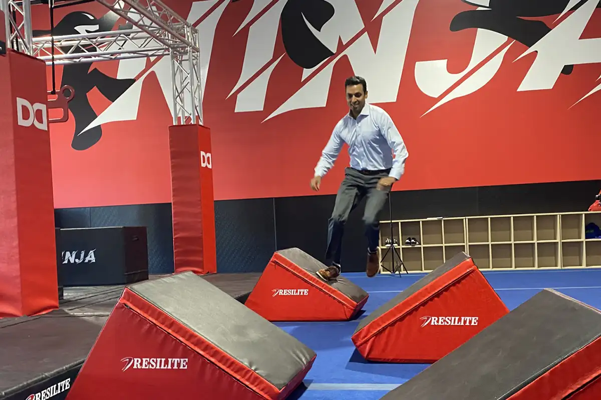 Congressman Subramanyam trying a Ninja obstacle course. 