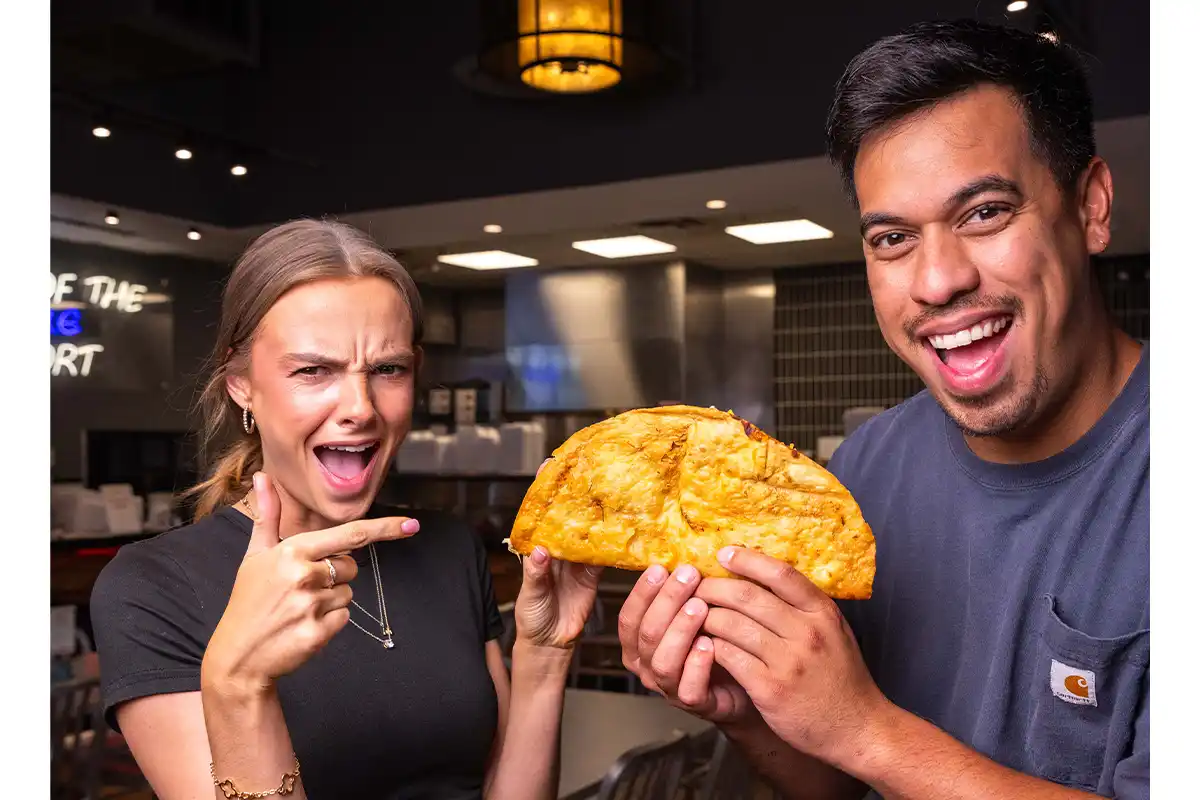 two people holding big tony taco
