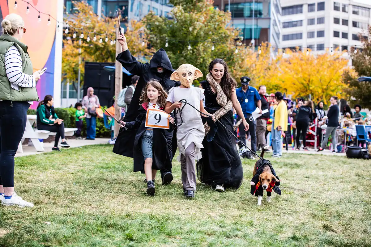 A family and their dog in Halloween costumes at the Boro at Tysons