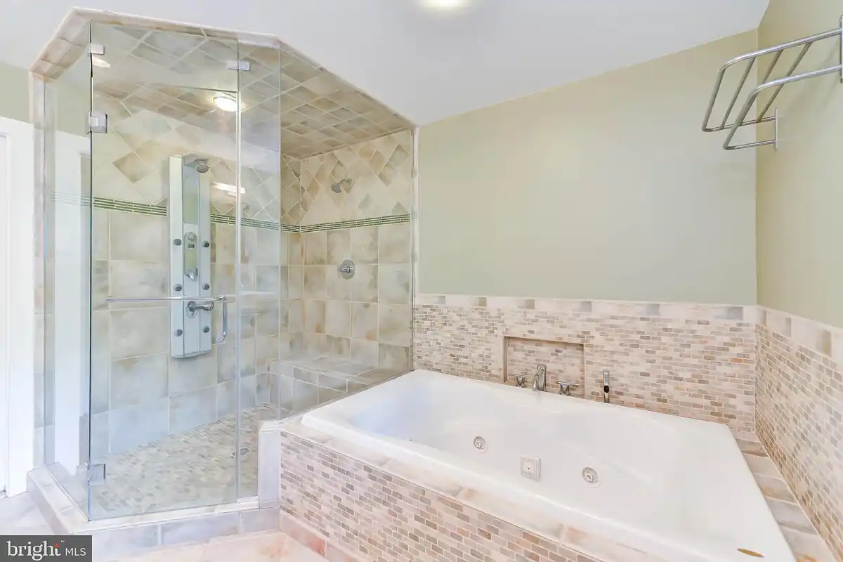 bathroom with steam shower and tub