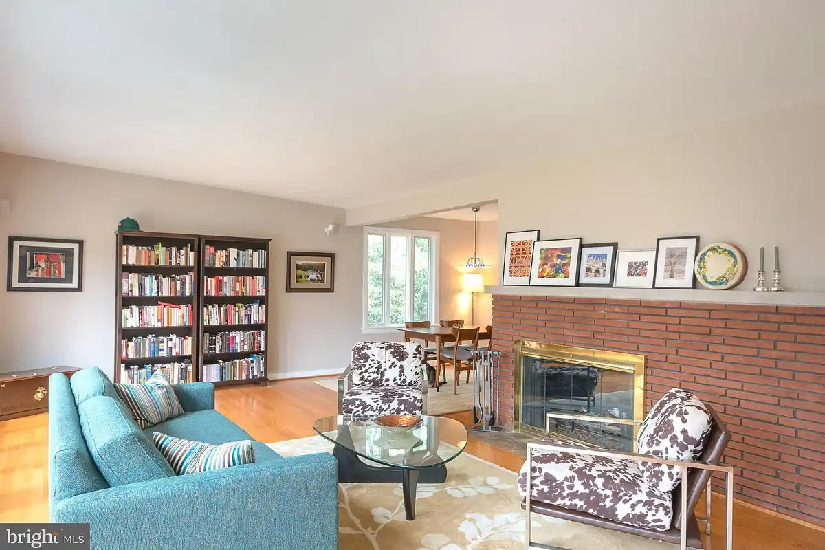 living room with gas fireplace and brick accents
