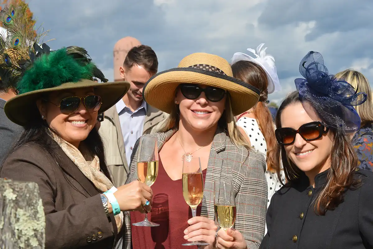 women wearing special hats at gold cup