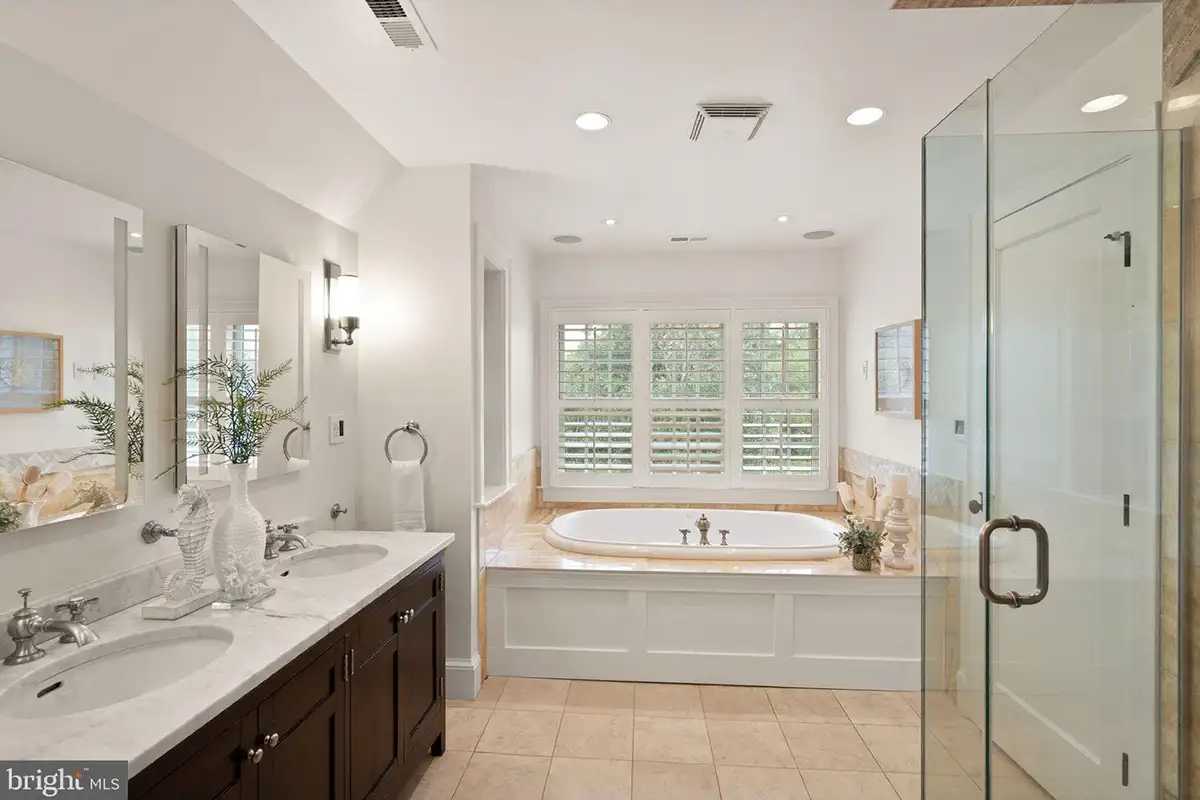 Primary bathroom with double vanities and a soaking tub at 1520 N Highland St. 