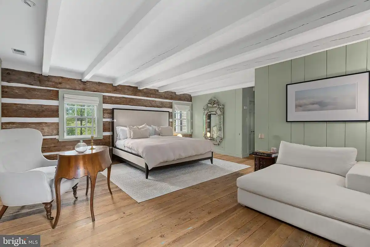primary bedroom with exposed wood walls