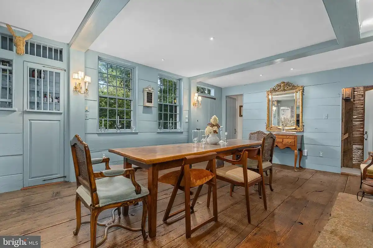 light blue dining room with oak floors