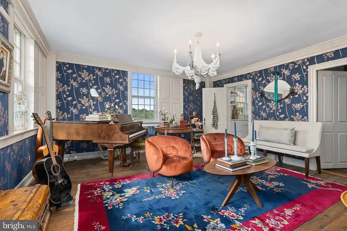 piano room with blue patterned wallpaper
