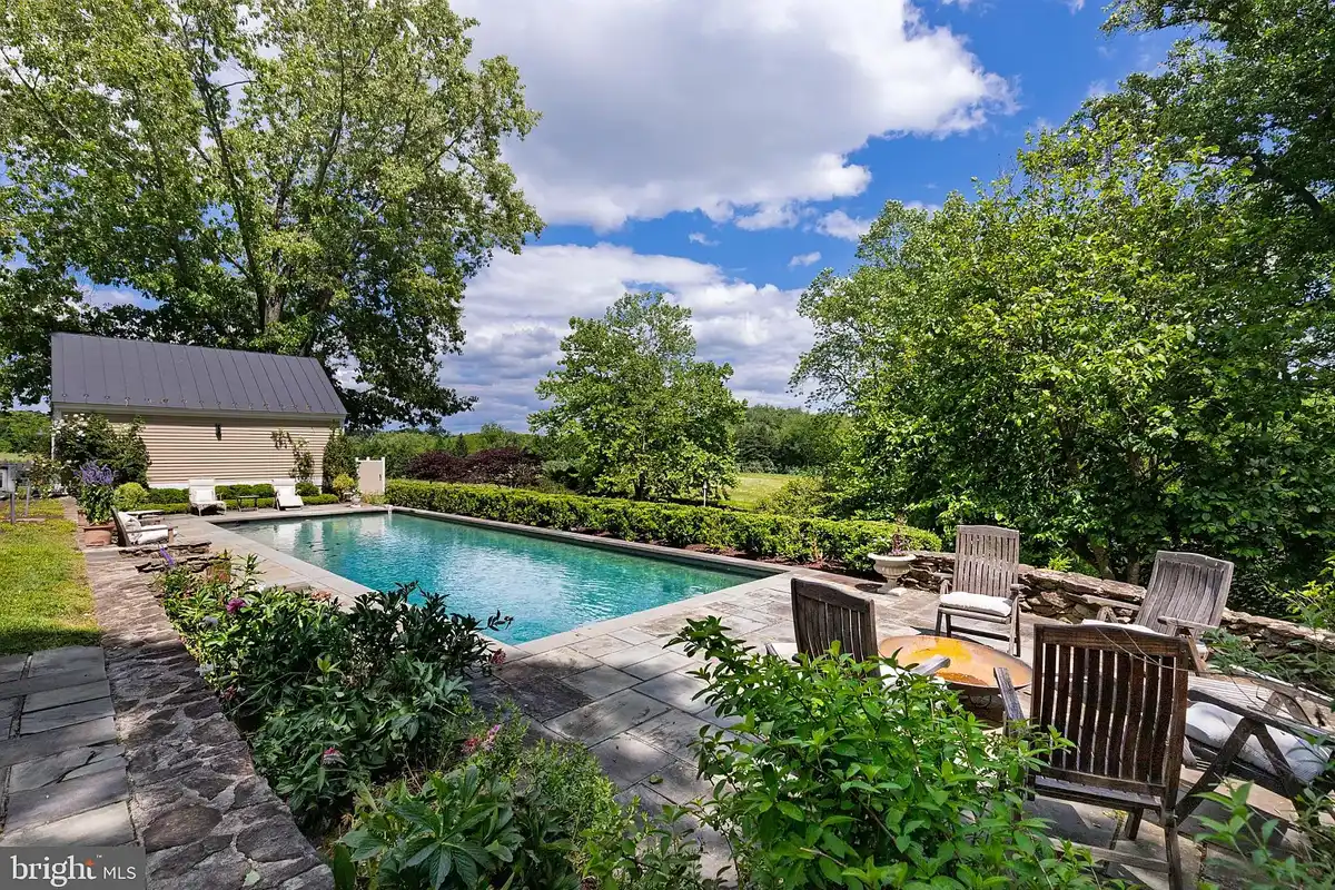 in-ground pool with stone patio