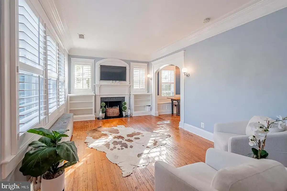 The living space with built-in storage and a fireplace at 222 Locust St.