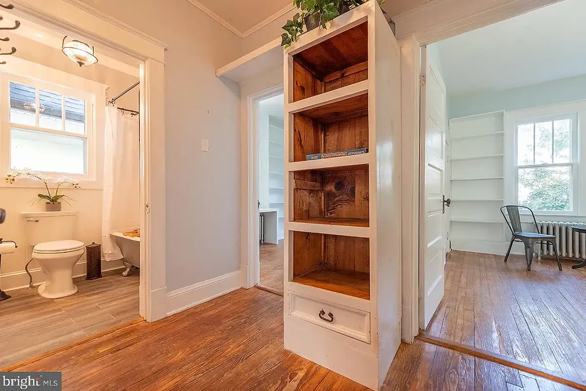 The hallway leading to the two main floor bedrooms and shared full bathroom at 222 Locust St.