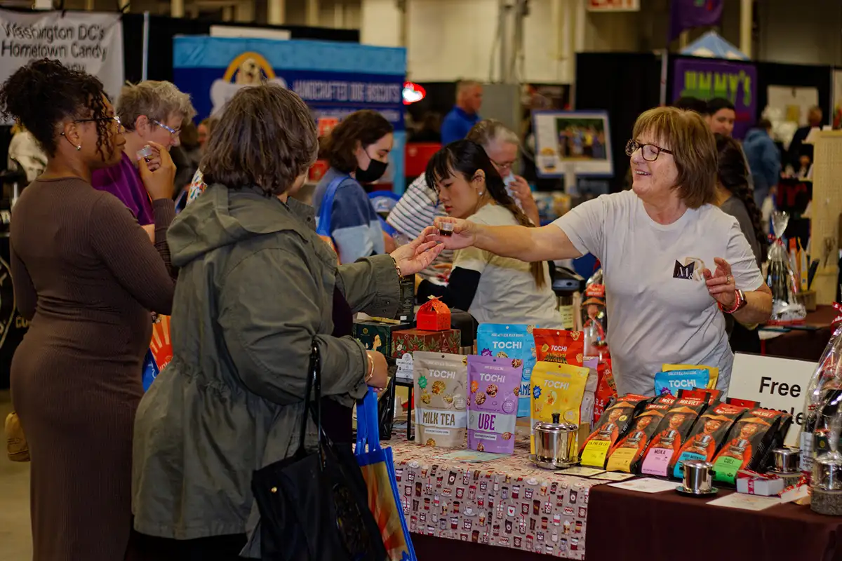 woman giving sample during DMV Chocolate and Coffee Festival