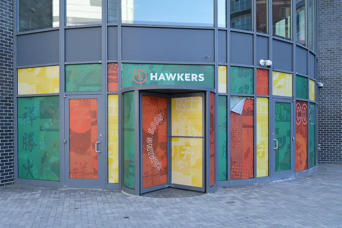 "Coming soon" signs for Hawkers Asian Street Food in the Mosaic District. 