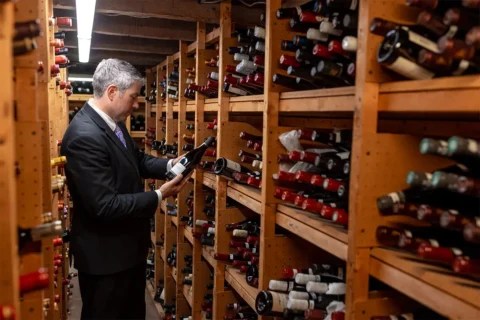 a man stands in the wine cellar at L’Auberge Provençale