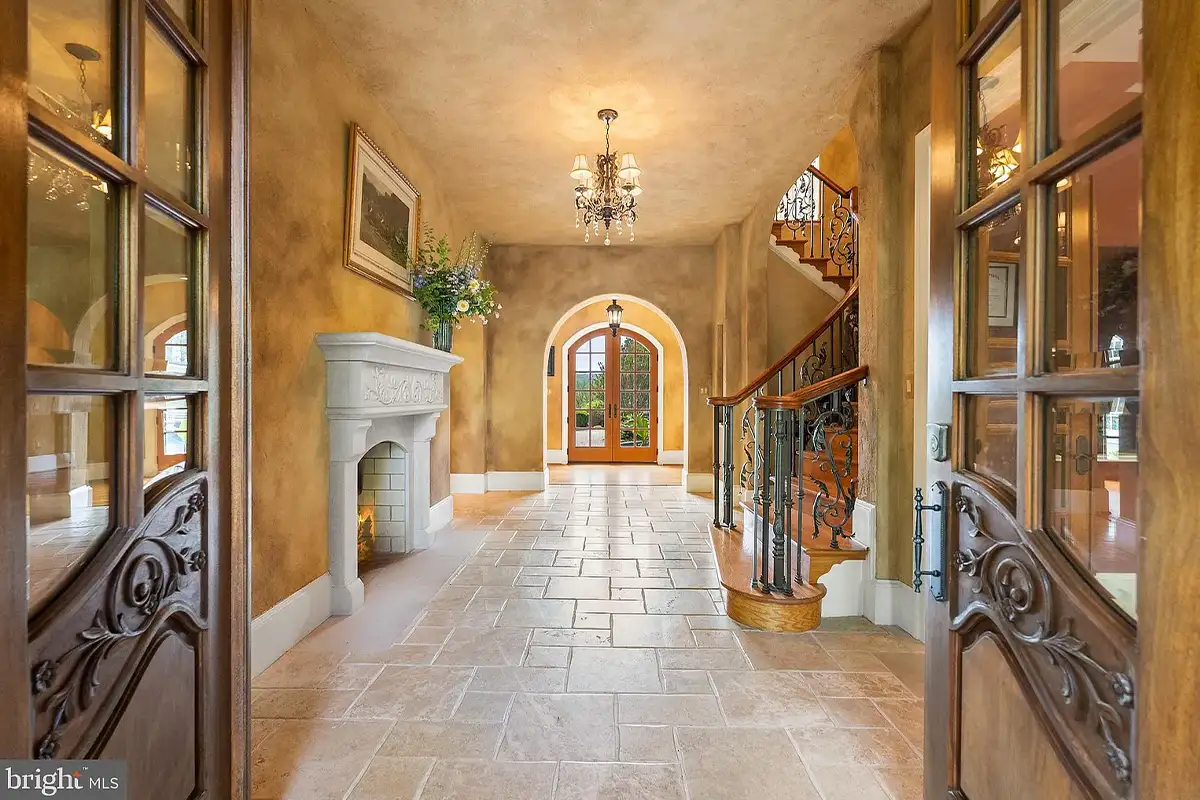 Entryway with arched doorways and wrought iron railing