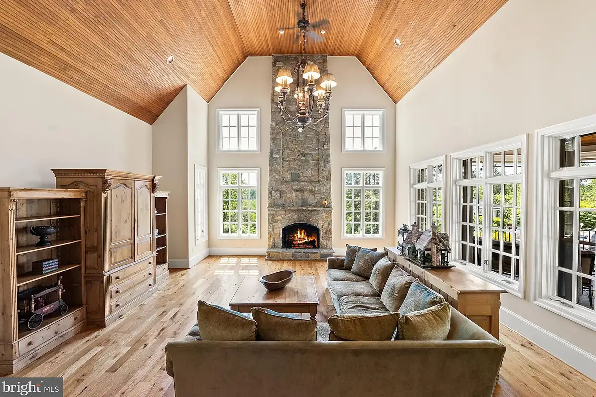 Living room with high ceilings and stone fireplace