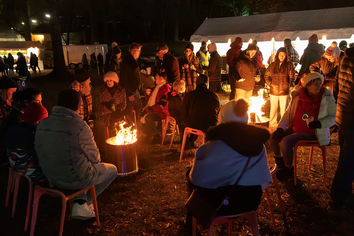 Guests warm up around a firepit at Reston Winterfest 2024.