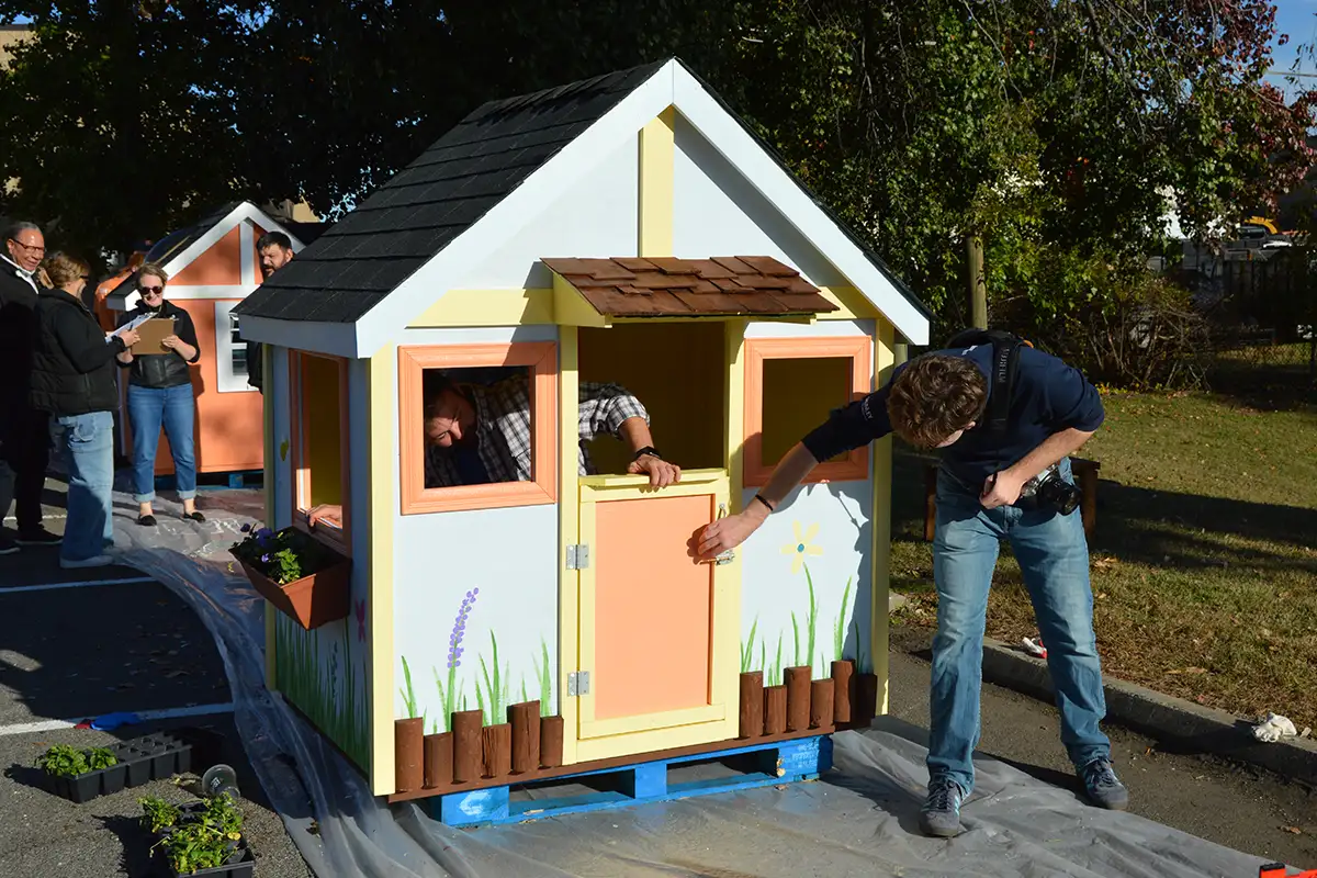 Grunley Construction team green's cottage themed playhouse. 
