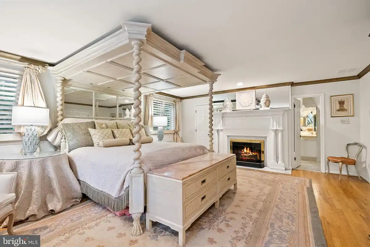 primary suite bedroom with fireplace
