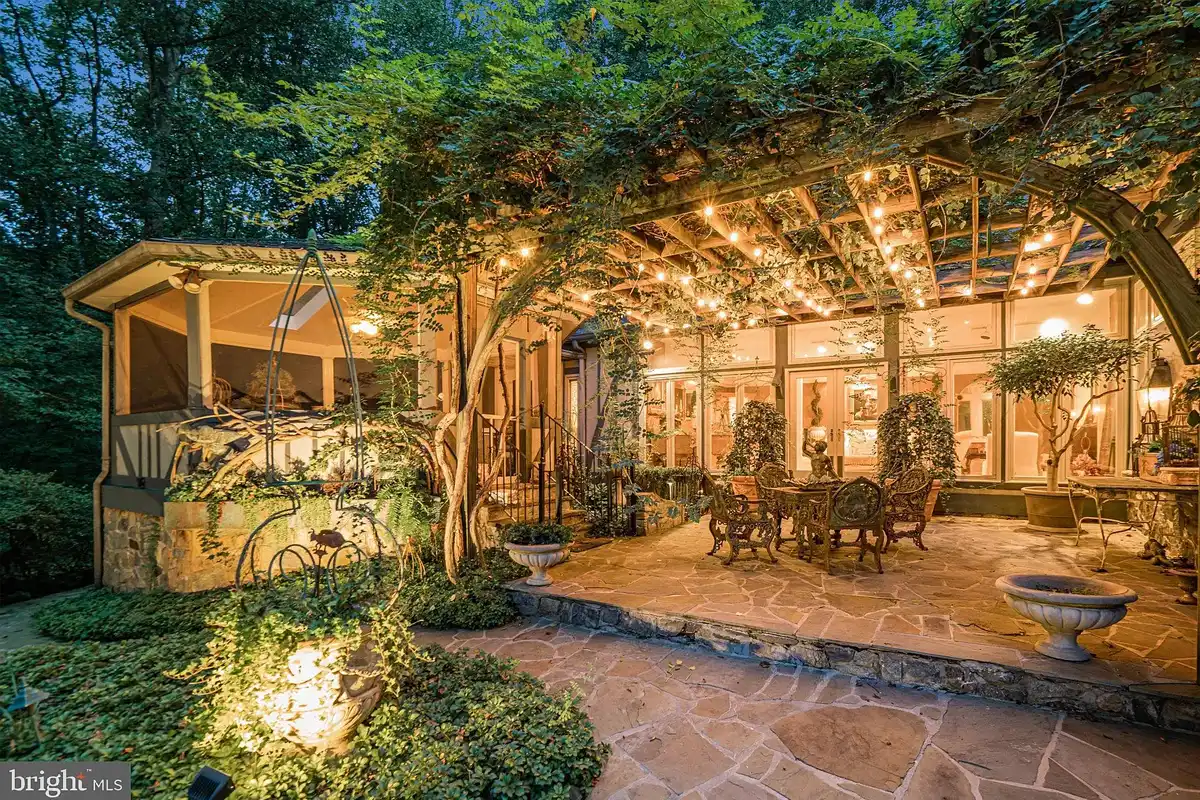 stone terrace with pergola covered in vines