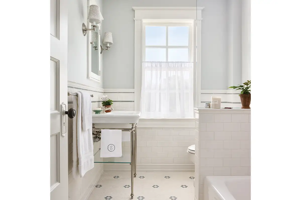 Small bathroom with white tiles and light blue walls