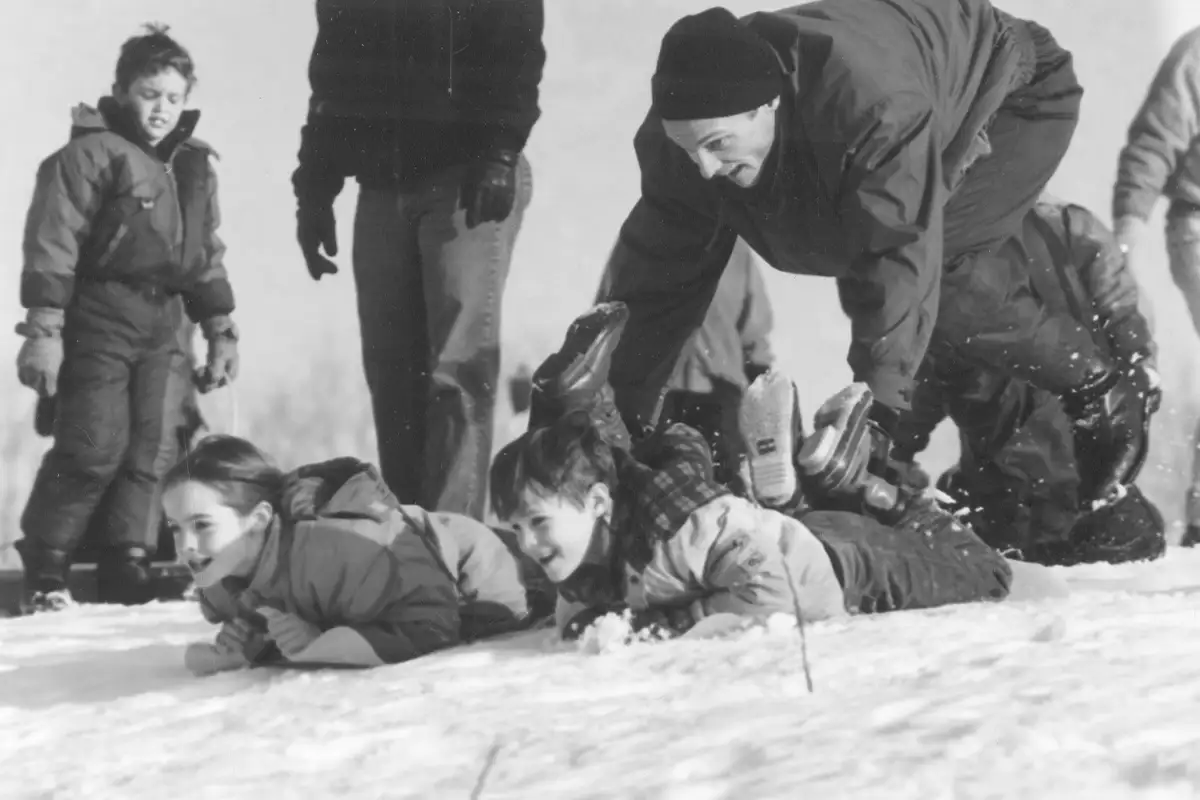 Kids sledding in snow