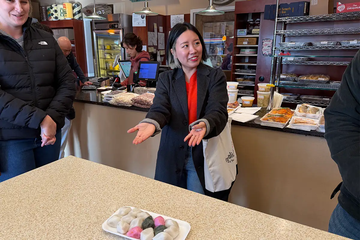 a Virginialicious Korean food tour guide describes food on a table in a restaurants