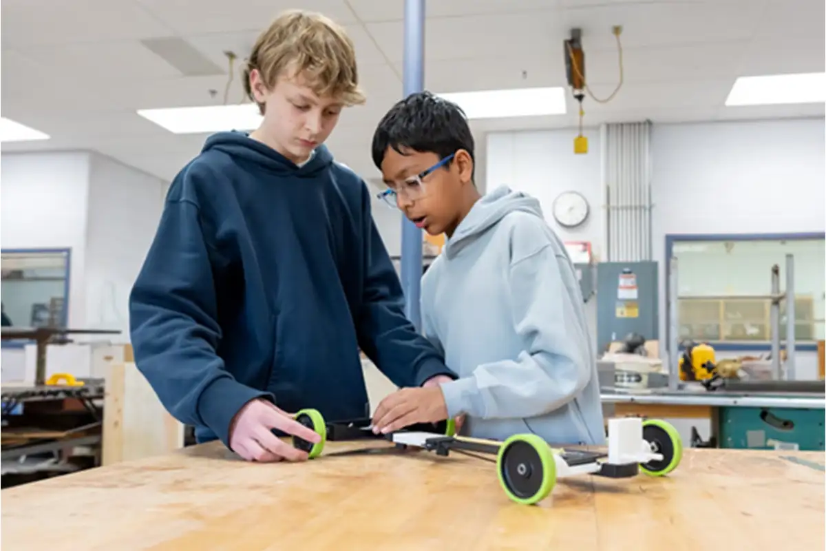 two students on Longfellow Middle School’s Science Olympiad team work on a project in a classroom