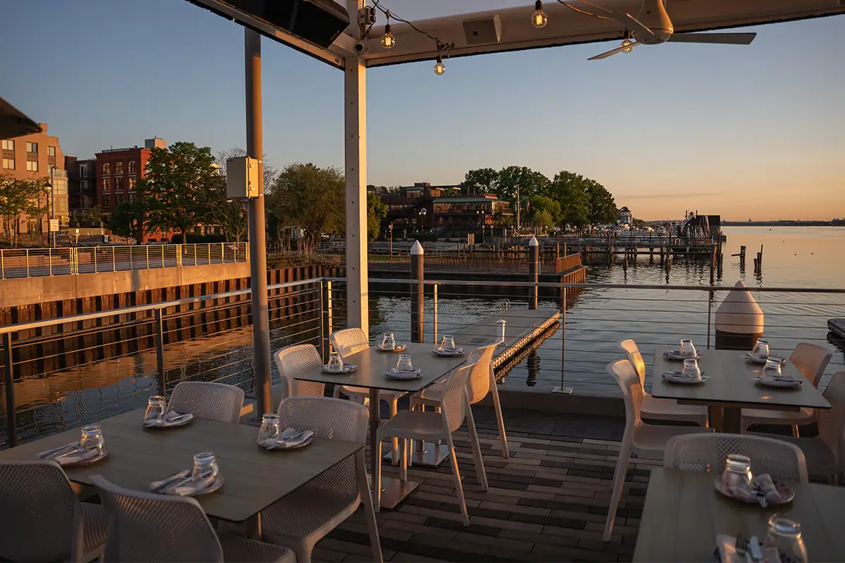 tables on the patio during sunset at BARCA Pier