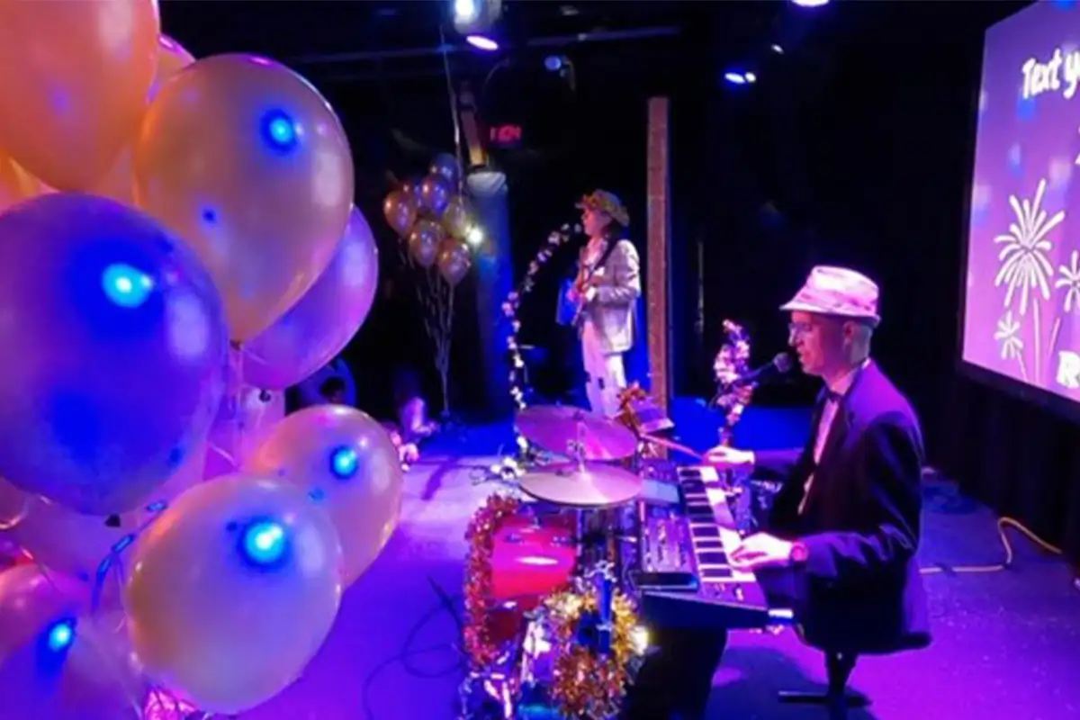 Entertainers play music on stage at a family New Year's Eve party at Jammin Java