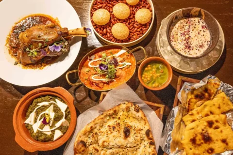 a table displaying multiple dishes of food at Pink Saffron