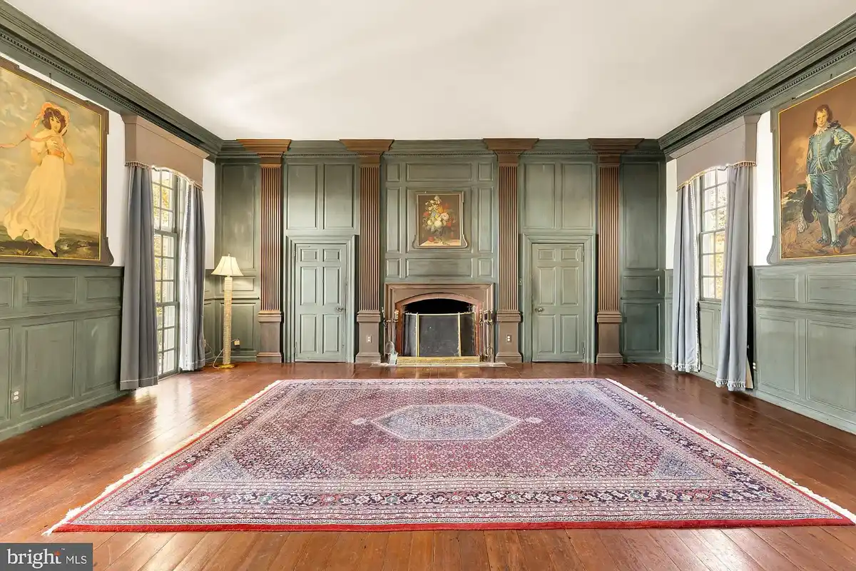 grand living room with historic paintings and original floors