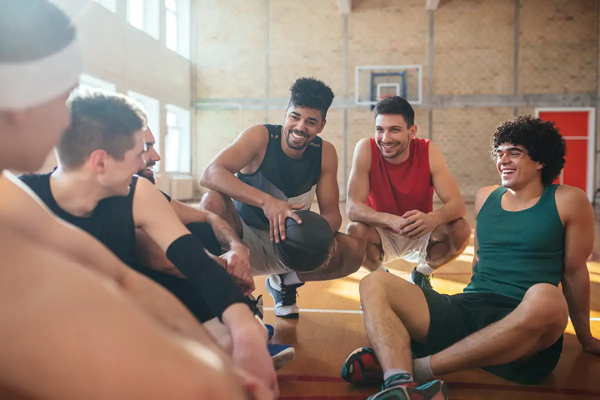 Students socializing on a basketball court