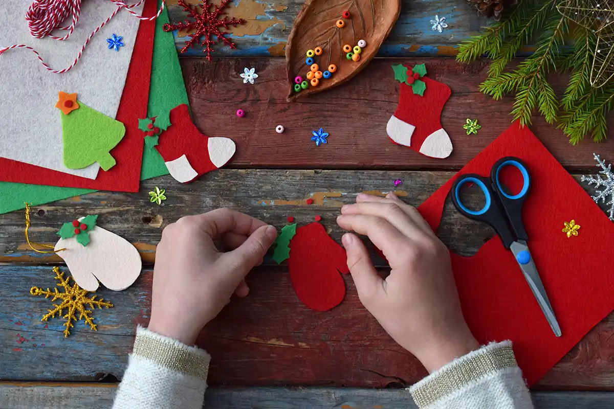 child making holiday ornaments