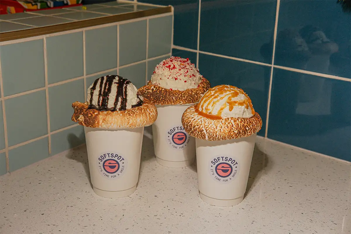 The S’mores Hot Chocolate shown in three versions including a classic preparation finished with dark chocolate drizzle, a salted caramel version with Maldon sea salt and caramel, and a peppermint version finished with crushed peppermint candy