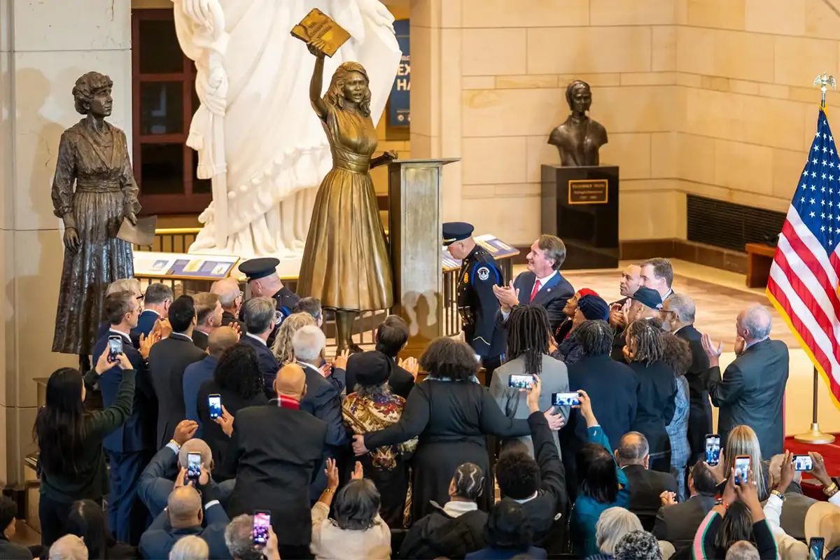 people clap and take photos of statue of civil rights activist Barbara Rose Johns at the U.S. Capitol