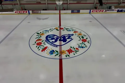 Center ice with emblem for flight 5342 victims