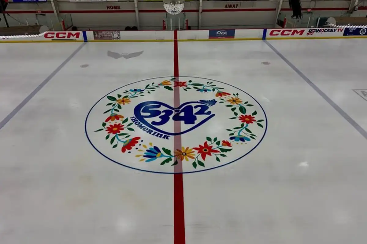 Center ice with emblem for flight 5342 victims