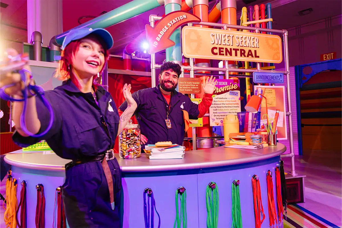 two employees inside the Hershey Super Sweet Adventure,