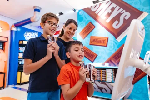 two bots and their mom with candy at Hershey Super Sweet Adventure