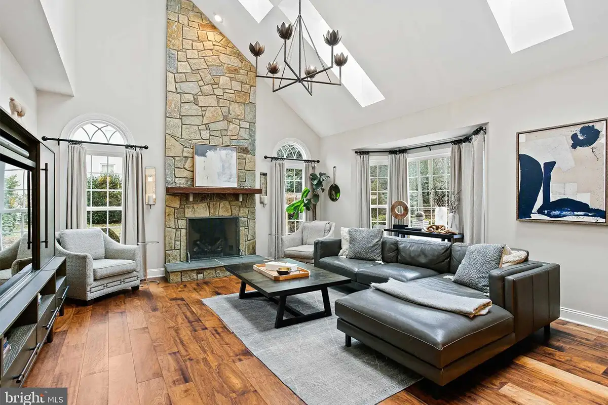 Family room on Round Pebble Lane with tall stone fireplace