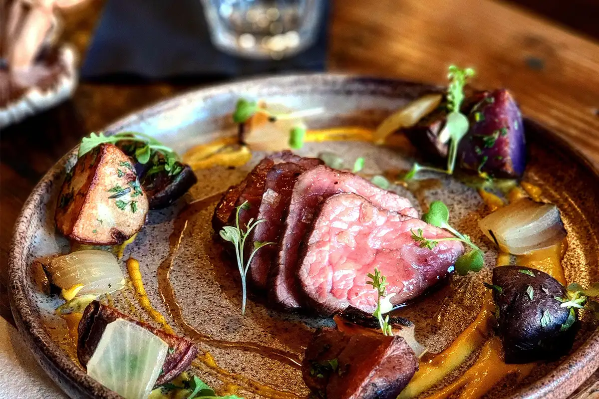 a steak and potatoes dish at foraged.