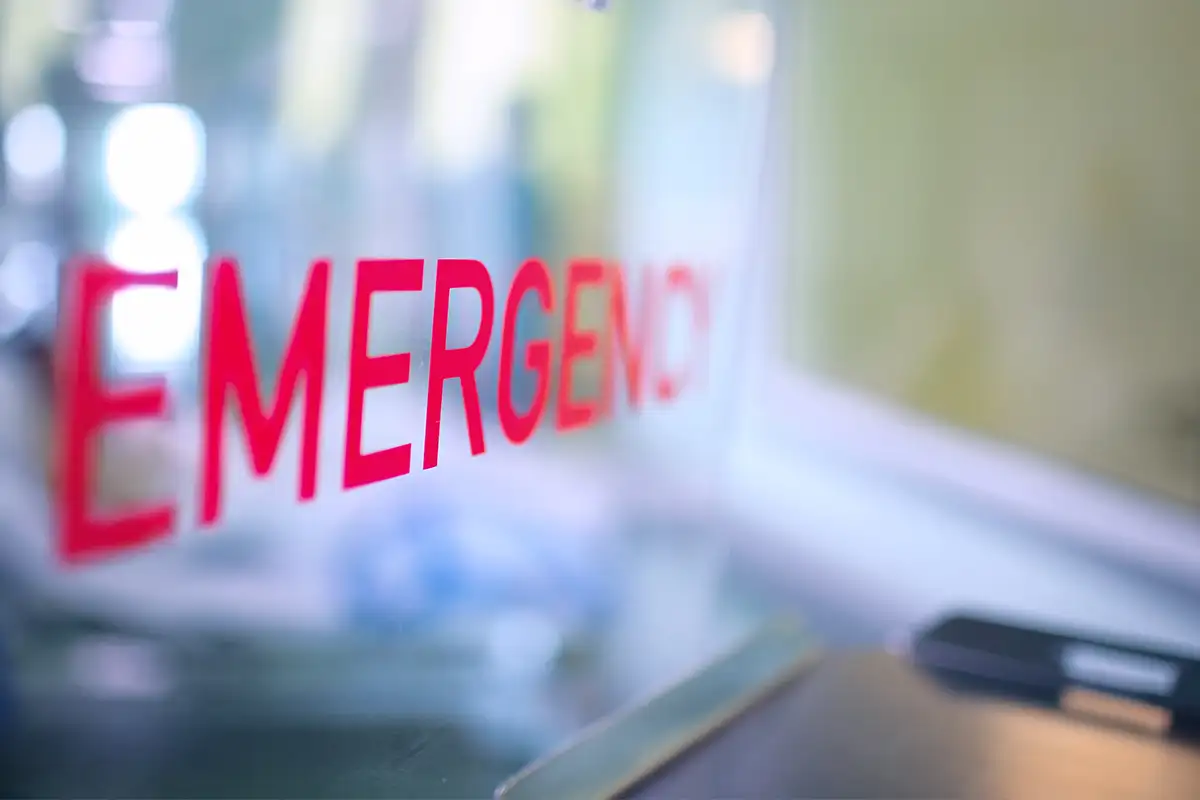 a transparent placard that says emergency