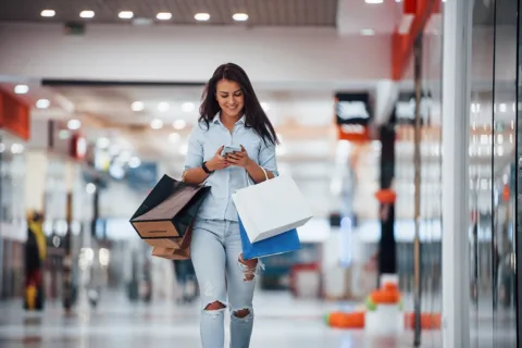 woman carrying shopping bags in mall