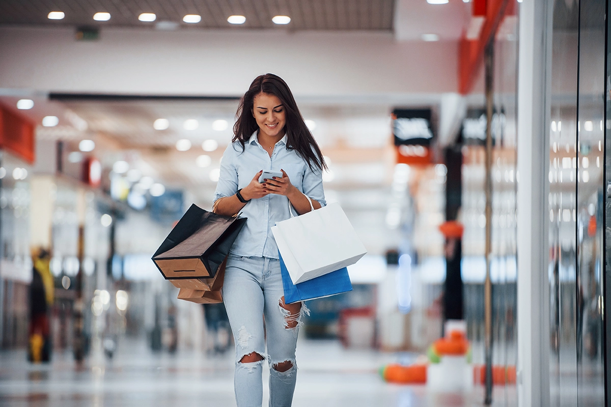 woman carrying shopping bags in mall