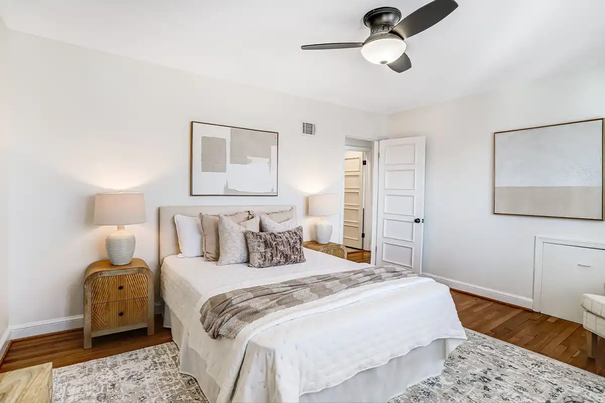 primary bedroom with rug and hardwood floors