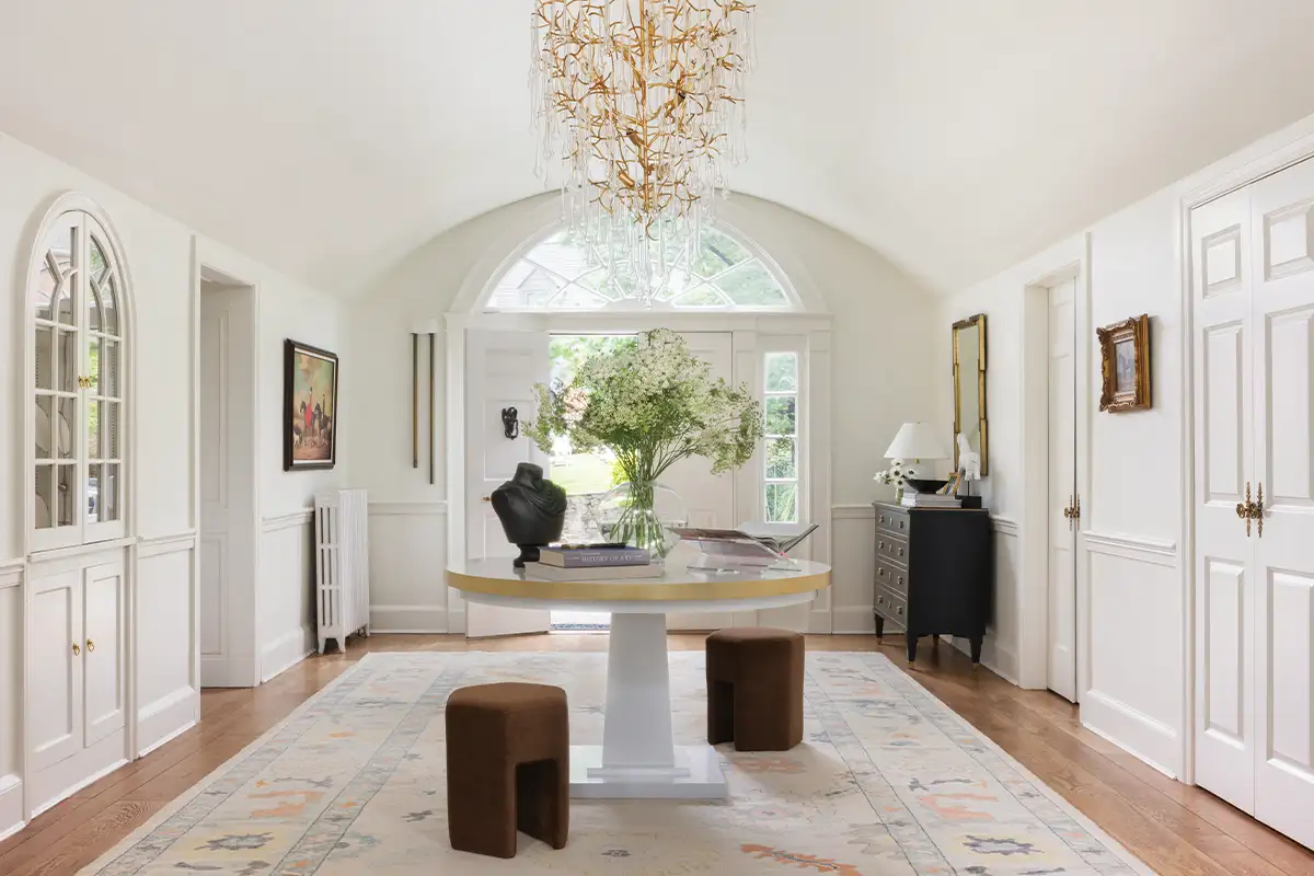 An entryway with white walls and arched details
