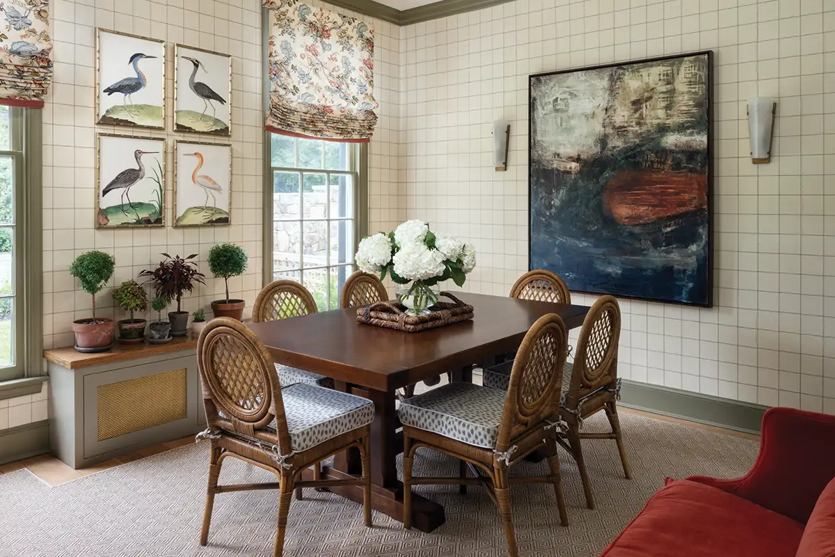 Schumacher’s Windowpane Embroidered Sisal wallpaper adds texture and pattern to the study’s walls. Framed Audubon bird prints add a timeless touch.