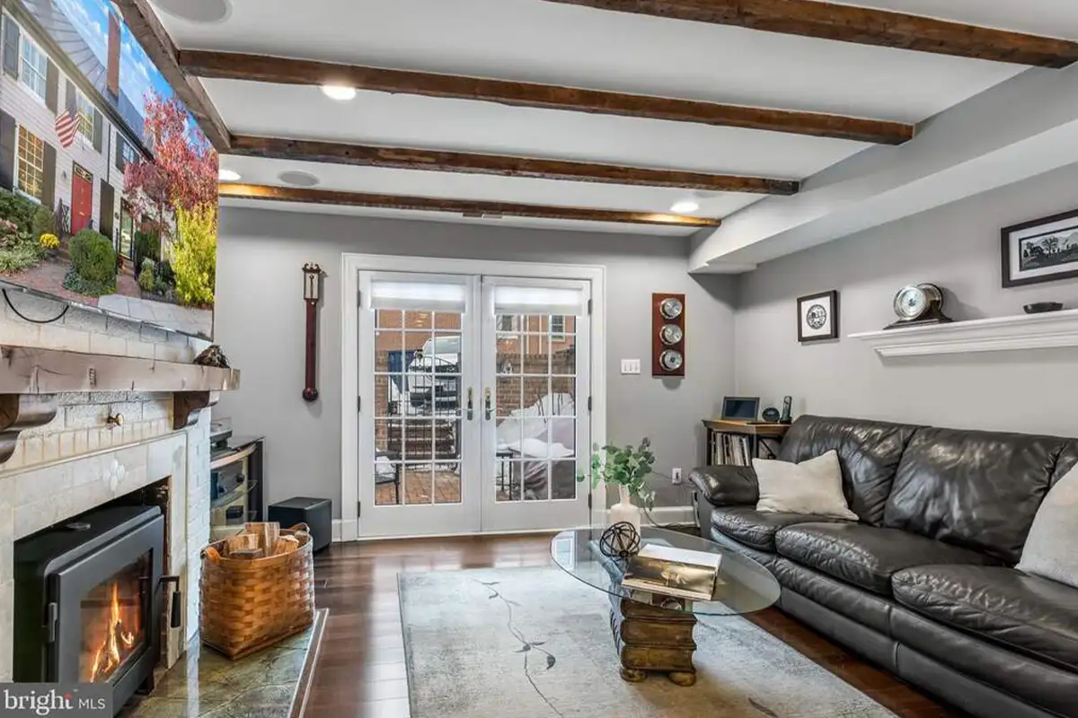 Family room with wood-burning stove and wood beams on ceiling