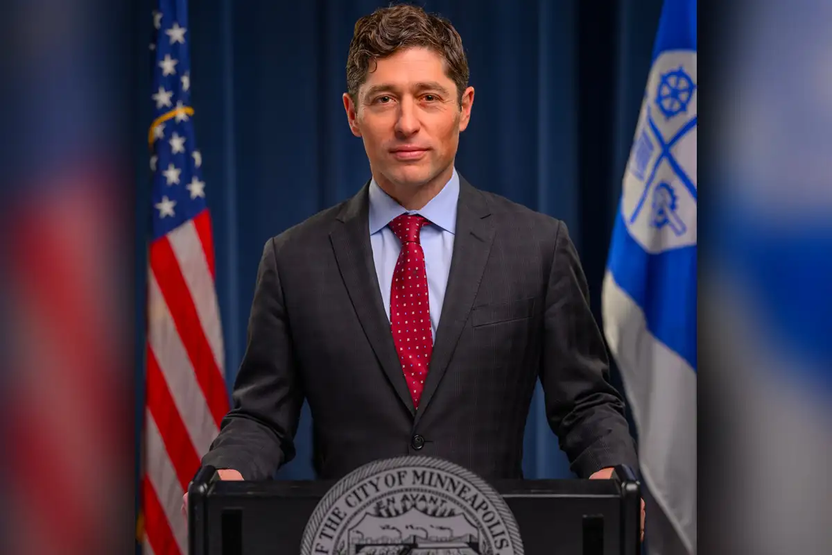 Minneapolis mayor Jabob Frey at the city's podium with the state and U.S. flag in the background